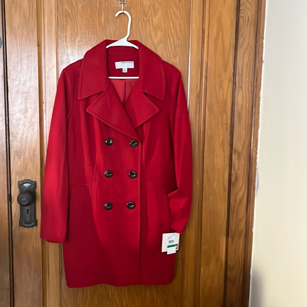 This lovely double breasted red peacoat has deep side pockets.